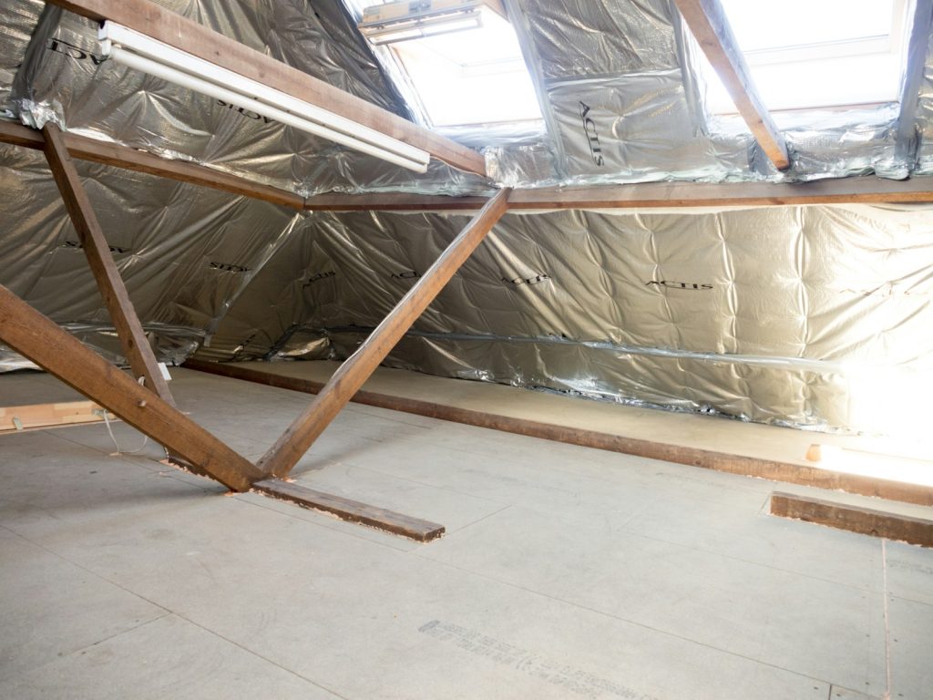 Insulated attic with wooden beams