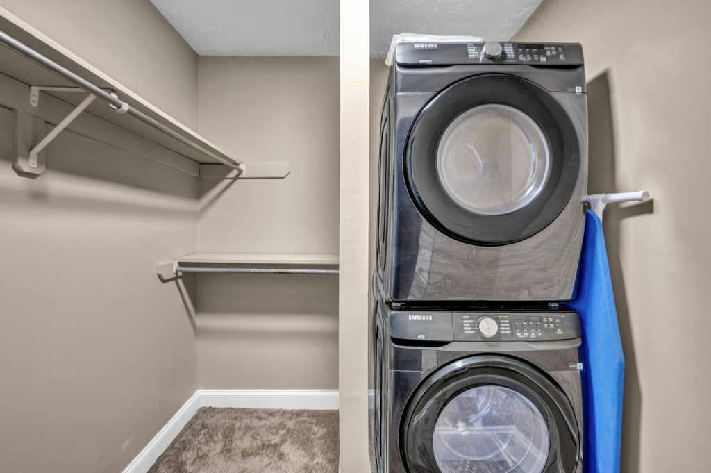 Stacked washer and dryer in a laundry closet