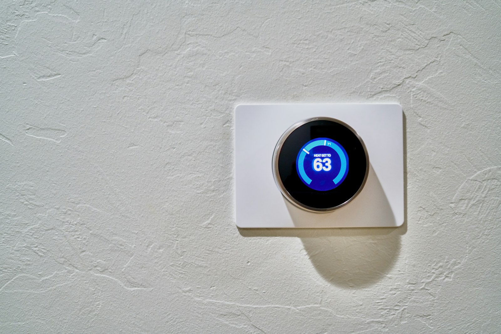 Wall thermostat set to 62 degrees