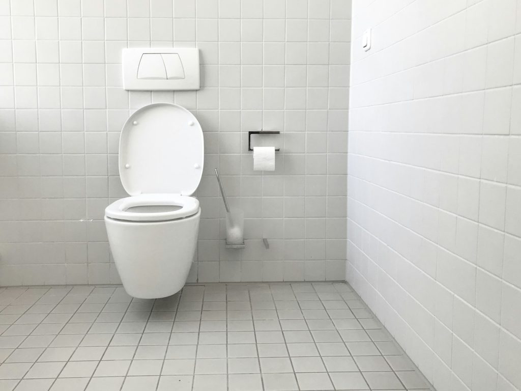 White toilet with tank in a bathroom