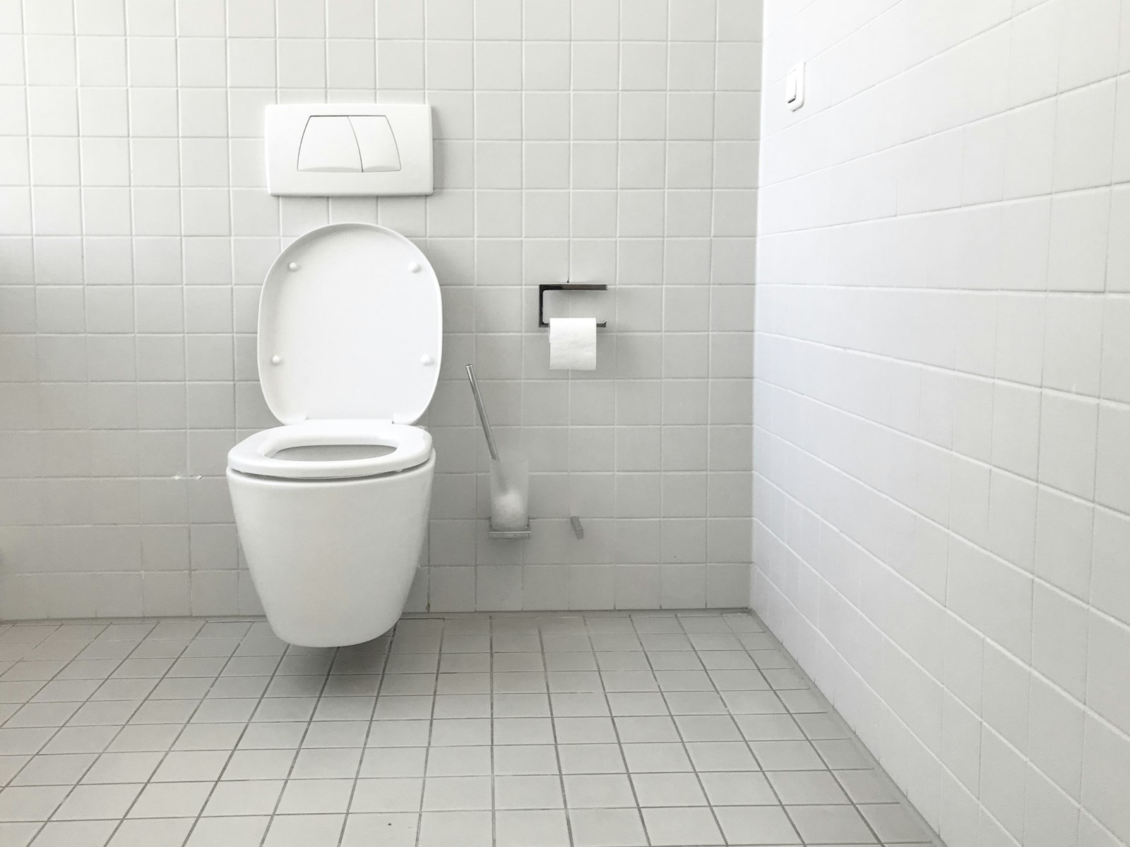 White toilet with tank in a bathroom