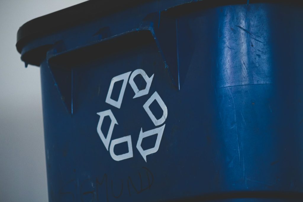 Recycling symbol on a blue recycling bin