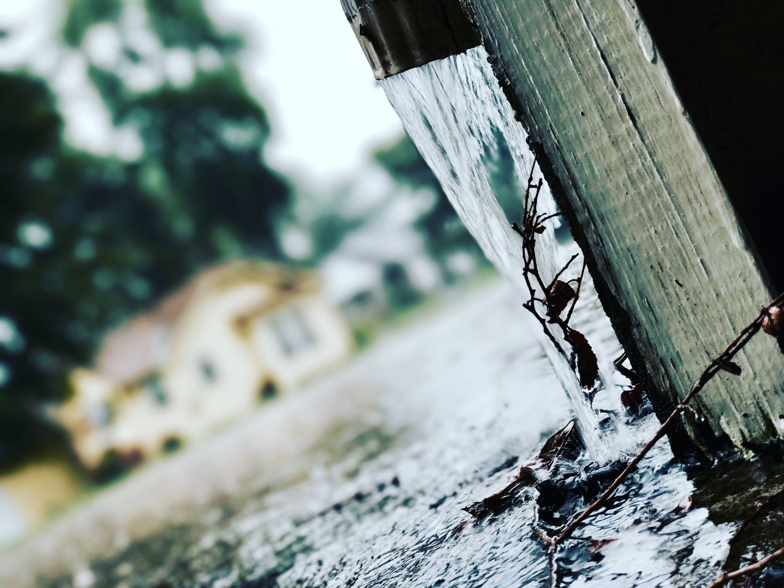 Rainwater pouring from a roof gutter