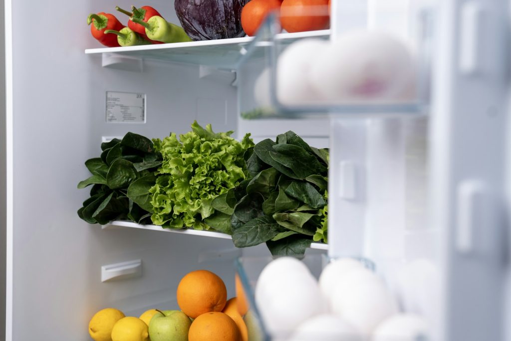 Refrigerator stocked with fresh fruits and vegetables