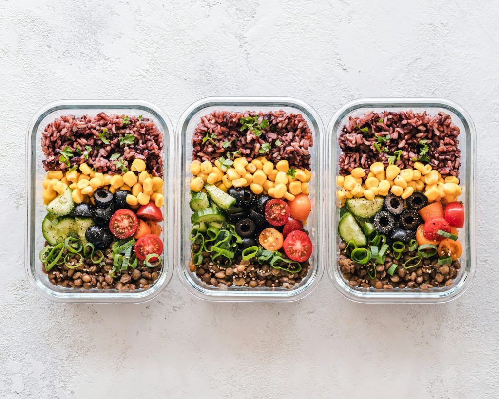Glass containers of leftover food prepped for meals